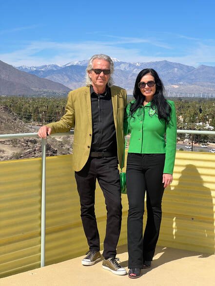 Annalisa Capurro and Mark Davis, directors of Capurro + Davis Design, on a rooftop with the Palm Springs mountains behind